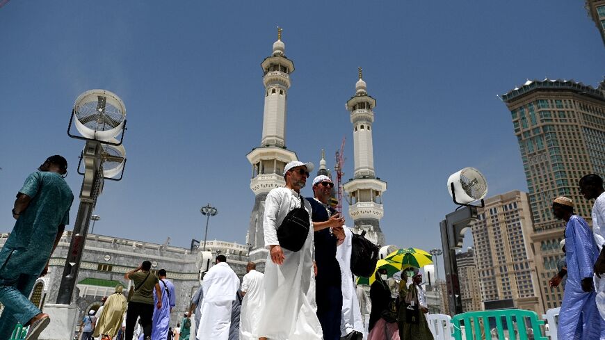 Pilgrims outside the Grand Mosque, where fans are installed to cool them as temperatures climb towards 45 degrees Celsius (113 degrees Fahrenheit)
