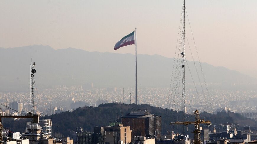 The Iranian capital of Tehran is seen in January 2023, with the country's flag fluttering in the wind