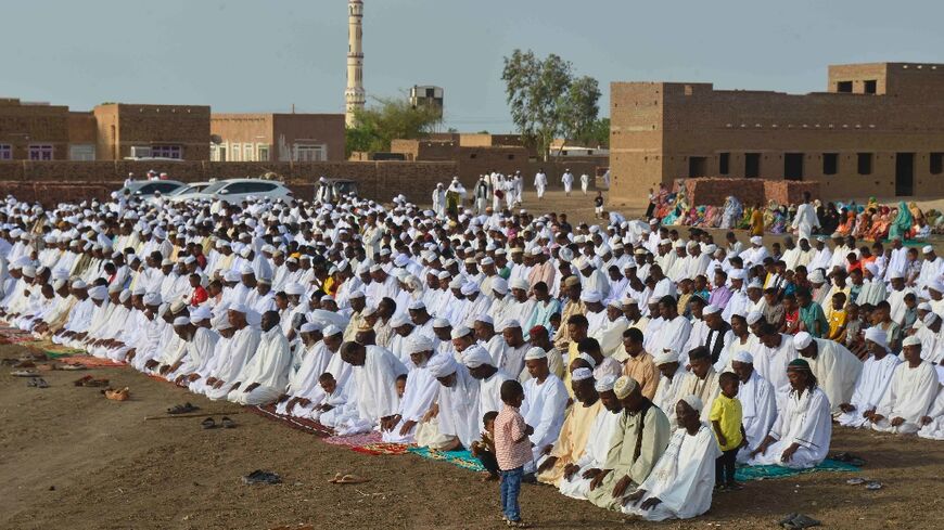 Sudanese Muslim worshippers who fled violence in Khartoum gather for Eid al-Adha prayers in Jazira region, south of the capital
