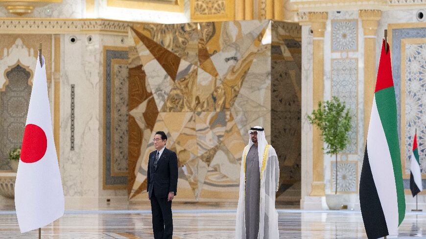 UAE President Sheikh Mohammed bin Zayed Al Nahyan (R) welcoming Japan's Prime Minister Fumio Kishida 