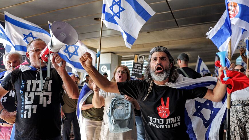 Anti-government protesters march at Israel's Ben Gurion Airport near Lod on July 3, 2023.