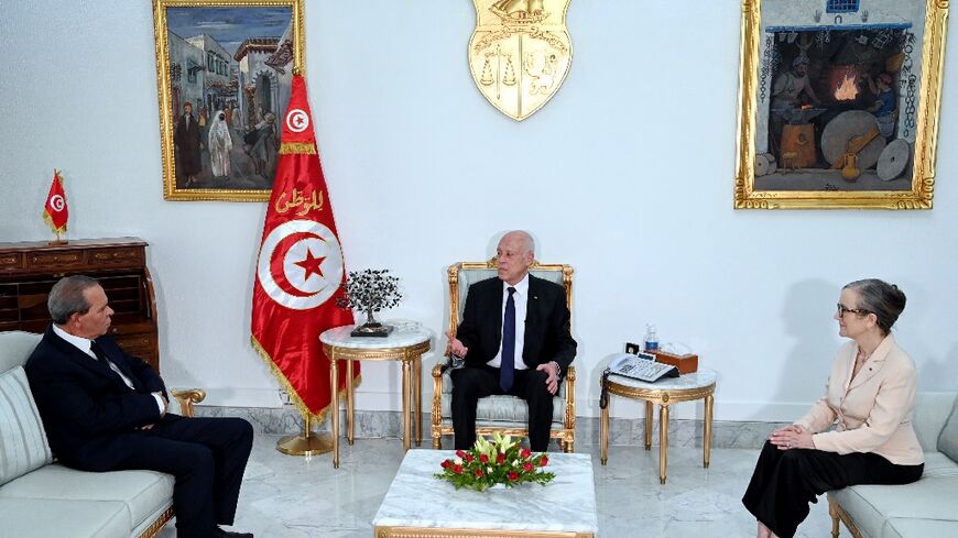 Tunisian President Kais Saied (C) meets outgoing prime minister Najla Bouden (R) and incoming Prime Minister Ahmed Hachani 