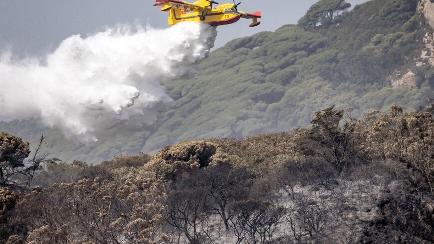 A Royal Moroccan Air Force firefighting plane douses a wildfire in Tangier