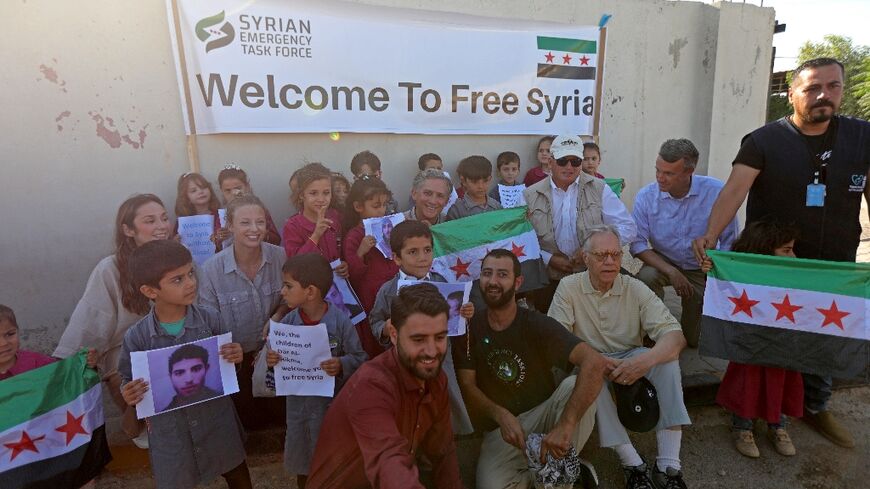 The members of Congress pose with orphaned children at a hospital in Syria's border town of Azaz