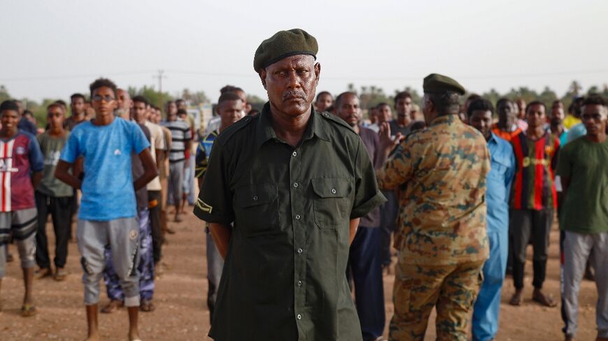 An officer of Sudan's regular army addresses new recruits in the Kassinger area of Northern State as commanders struggle with a shortage of infantrymen in its war against the seasoned paramiliaries of the Rapid Support Forces