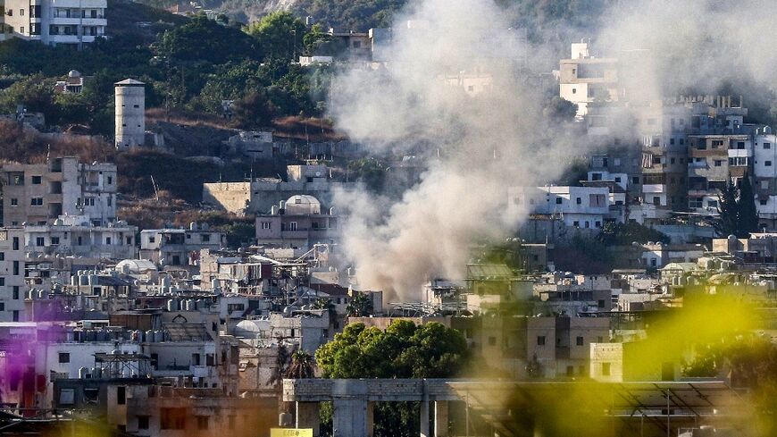 Smoke billows after a projectile hits near a centre of the Palestinian Fatah movement in the Ain al-Helweh camp for Palestinian refugees in Lebanon's southern coastal city of Sidon on September 10, 2023