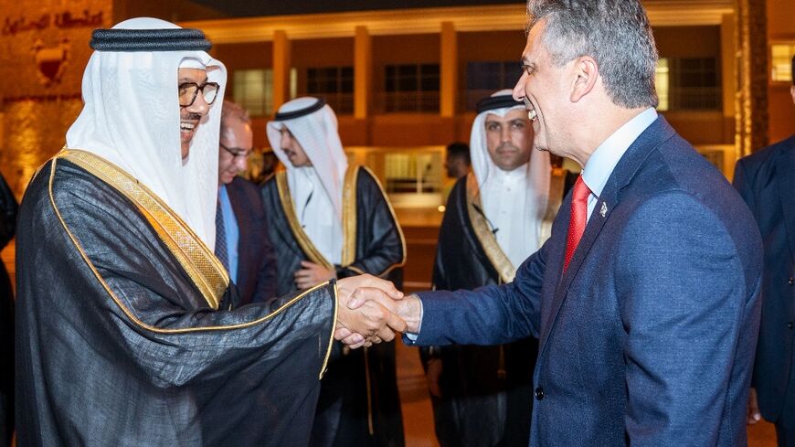 Bahrain Foreign Minister Abdullatif bin Rashid al-Zayani welcoming his Israeli counterpart Eli Cohen to Manama