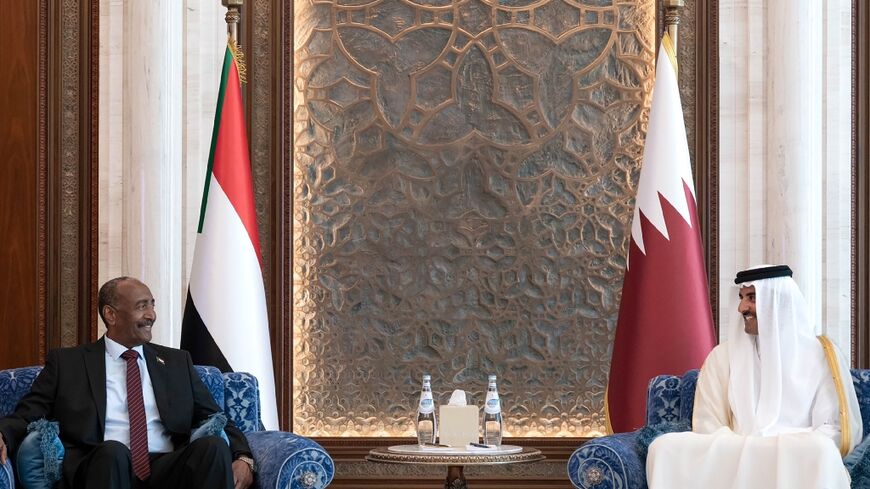 Qatar's Emir Sheikh Tamim bin Hamad Al Thani (R) meets with Sudan's army chief Abdel Fattah al-Burhan in Doha