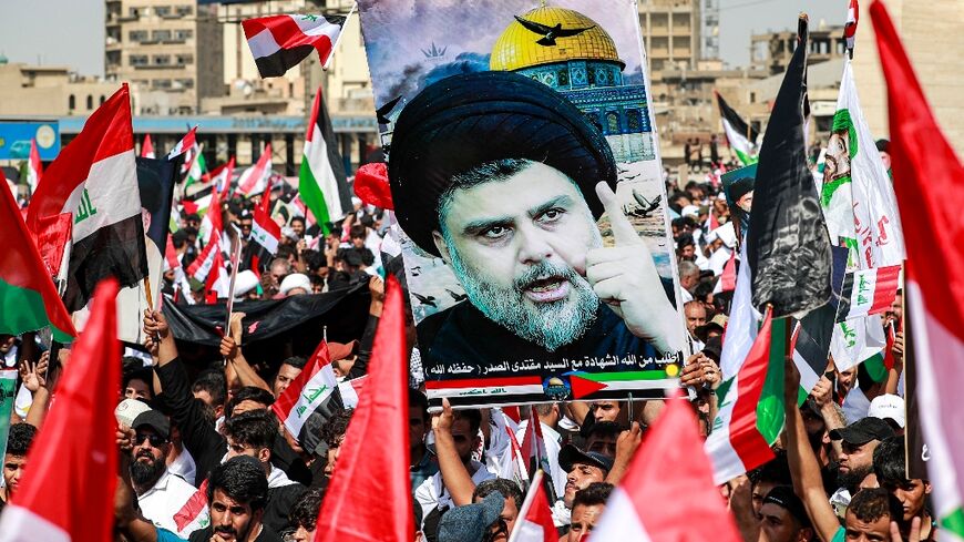 Supporters of Iraqi Shiite cleric Moqtada al-Sadr gather at Baghdad's Tahrir Square during an anti-Israel demonstration on October 13, 2023