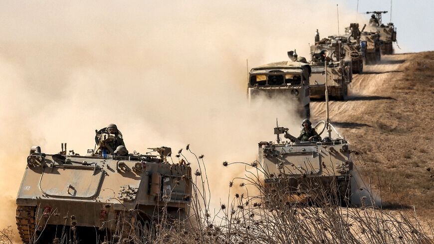 Israeli army infantry fighting vehicles deploy along the border with the Gaza Strip in southern Israel, ahead of an expected ground offensive in the Palestinian territory