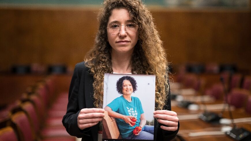 Israeli-German Noam Har Tzvi holds a picture of her missing friend Shoshan Haran 