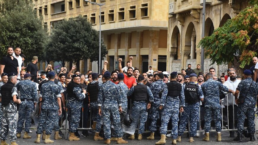 Police stop men from intercepting a march in support of liberties in Beirut