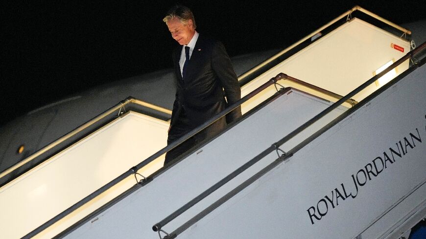 US Secretary of State Antony Blinken steps off a plane as he returns to Amman, Jordan following marathon talks in Israel