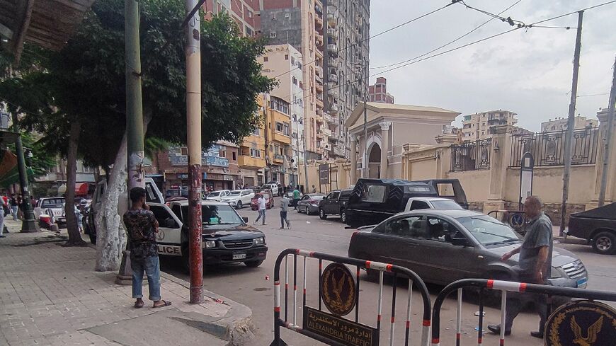 Egyptian police at the site where a policeman killed two Israeli tourists and their local guide in Alexandria
