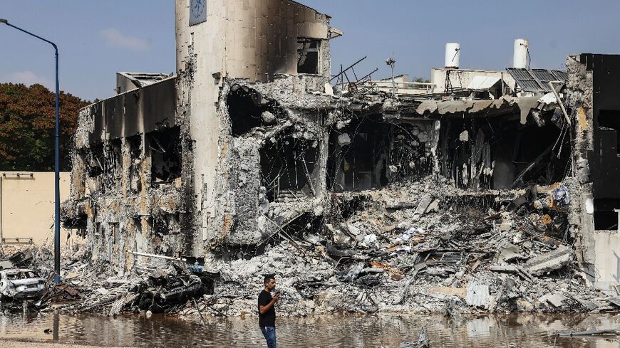 A man walks past an Israeli police station in Sderot after it was damaged during battles to dislodge Hamas militants 