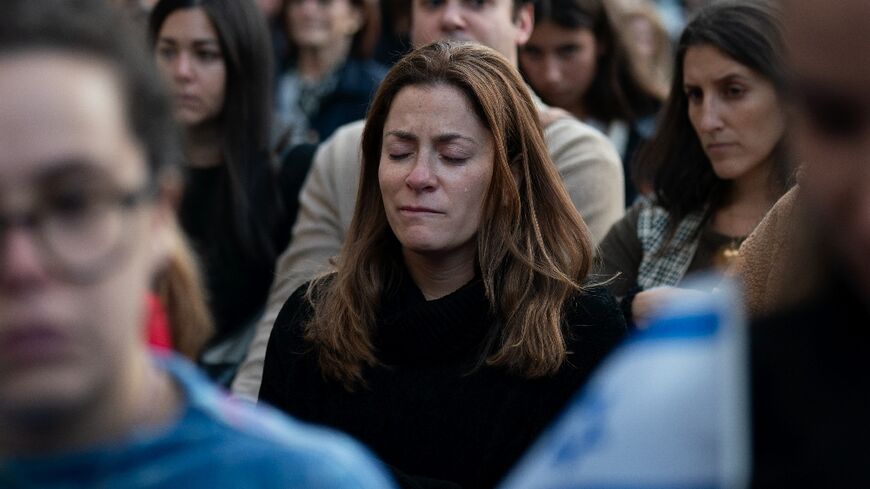 A person cries during a prayer service and candlelight vigil for Israel at Temple Emanu-El in New York City on October 9, 2023, after the Palestinian militant group Hamas launched an attack on Israel