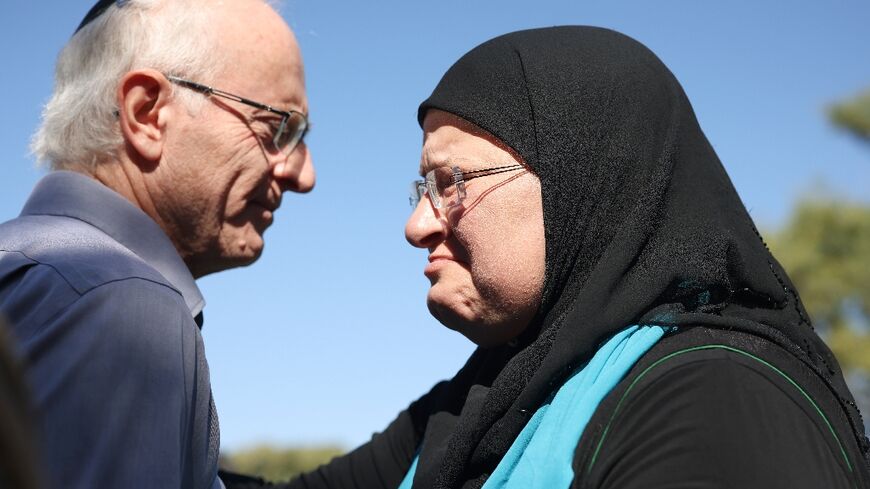 Vivian Silver's brother Nir greets Arab-Israeli peace activist Ghadir Hani at the memorial