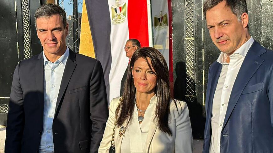 Spanish Prime Minister Pedro Sanchez (L) and his Belgian counterpart Alexander De Croo (R) visit the Rafah border crossing between Egypt and Gaza, accompanied by Egyptian International Cooperation Minister Rania al-Mashat