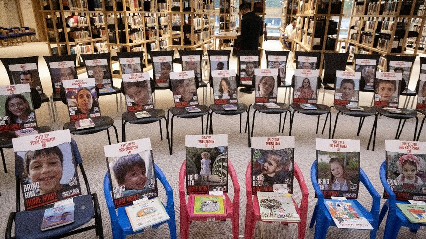Chairs with books and pictures of hostages held by Hamas are seen at Israel's newly opened National Library