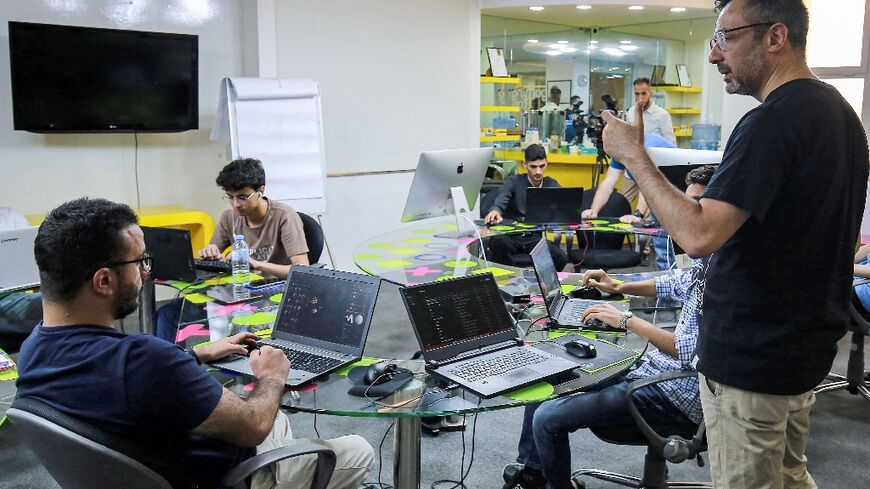 Nour Khrais, technical partner in The Jordan Gaming Lab, which provides equipment and educational courses to young people on all aspects of the gaming industry, talks to his team at their office in Amman