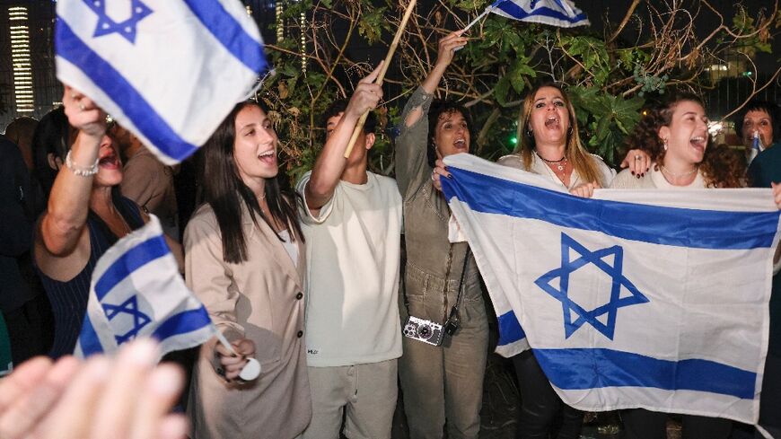 Israelis cheer as a helicopter carrying released hostages lands in Tel Aviv
