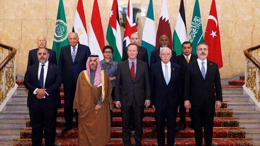Britain's Foreign Secretary David Cameron (front row C) poses with Islamic and Arab counterparts