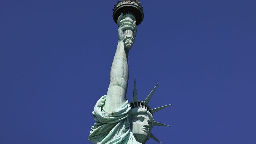 The poem from 19th-century activist and poet Emma Lazarus "New Colossus" is engraved on the base of New York's Statue of Liberty as an ode to US immigrants 