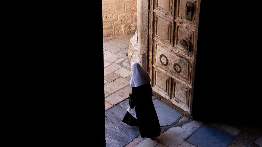 A nun leaves the Church of the Holy Sepulchre in Jerusalem’s Old City on November 21