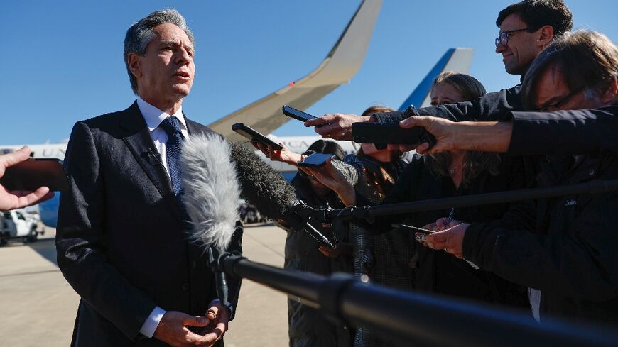 US Secretary of State Antony Blinken talks to reporters prior to boarding his aircraft at Joint Base Andrews on his way to the Middle East and Asia 