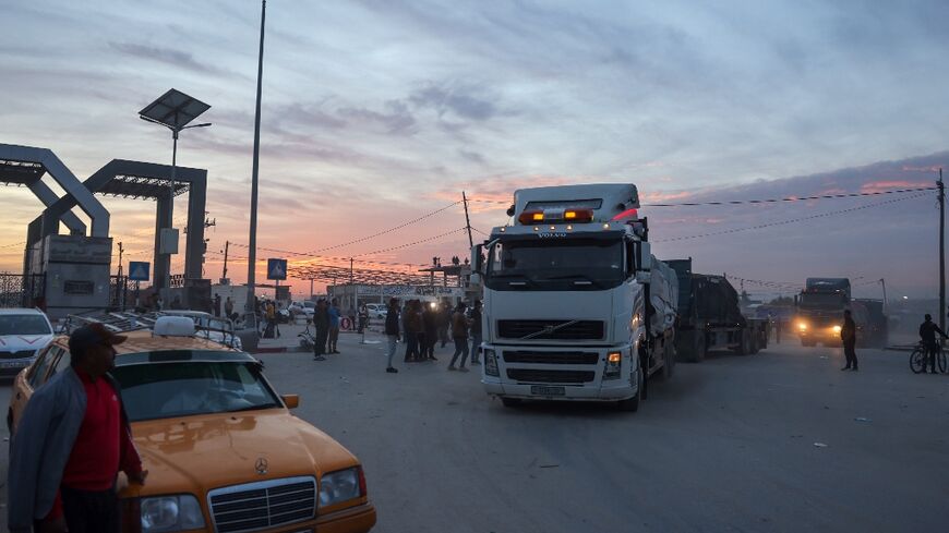 Trucks carrying humanitarian aid enter the Gaza Strip via the Rafah crossing with Egypt on November 25, 2023
