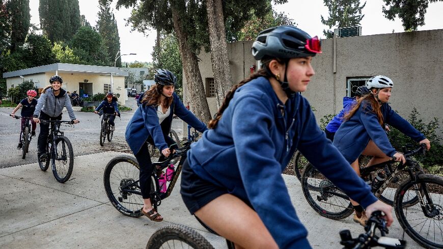 Teenagers from kibbutz Nahal Oz ride bicycles in kibbutz Mishmar Haemek in northern Israel