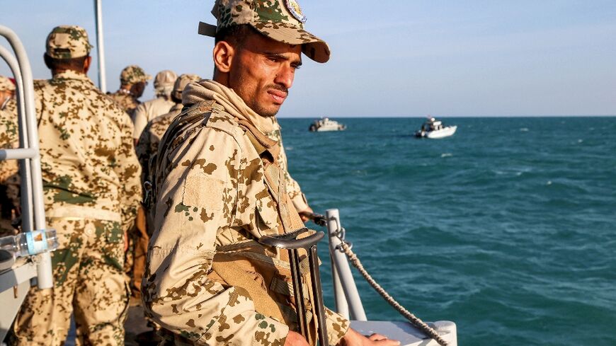 A Yemeni coastguard member loyal to the internationally recognised government in a patrol boat in the Red Sea off of the government-held town of Mokha, close to the strategic Bab al-Mandab Strait, on December 12, 2023