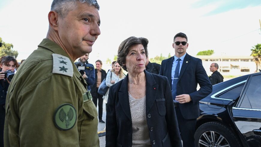 French Foreign and European Affairs Minister Catherine Colonna speaks with spokesperson of the Israeli army Colonel Olivier Rafowitcz upon arrival at the Shura army base near Ramle in central Israel