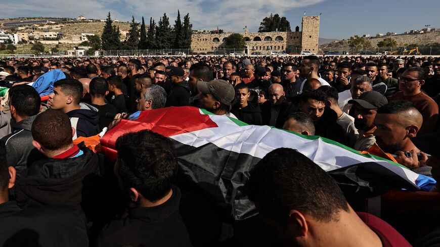 Palestinian mourners carry the bodies of men killed in the village of al-Fara during an Israeli raid in the occupied West Bank, Dec. 8, 2023.