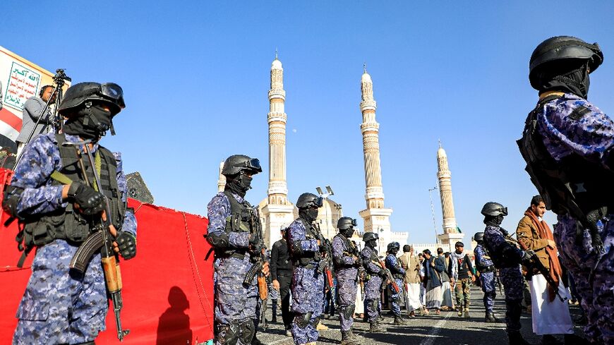 Yemen's Huthi-affiliated security forces stand guard during a march in solidarity with the people of Gaza in the capital Sanaa 