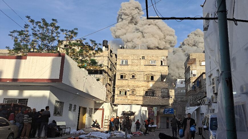 Palestinians take cover after an air strike near Gaza's Kamal Adwan hospital on November 22 