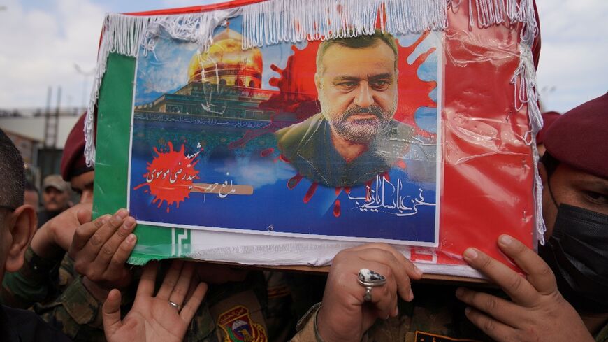 Honour guards carry the coffin of Razi Moussavi, a senior commander in the Quds Force of Iran's Islamic Revolutionary Guard Corps, in Iraq's holy city of Najaf