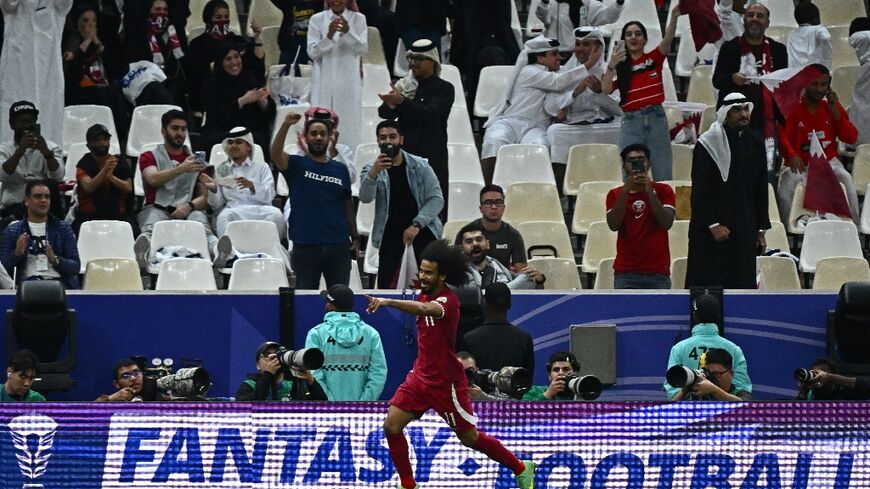 Qatar's forward Akram Afif celebrates after scoring his team's third 