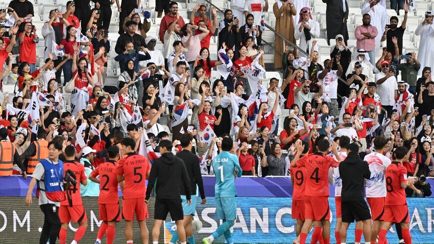 South Korea's players celebrate with their fans