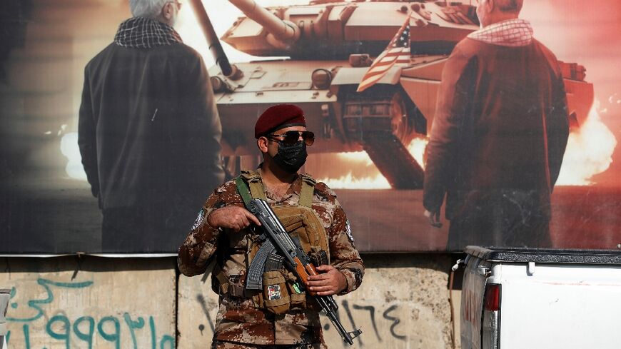 A paramilitary of the Hashed al-Shaabi (Popular Mobilisation) stands guard during the funeral in Baghdad of a fellow fighter killed in American air strikes targeting Iran-backed groups 