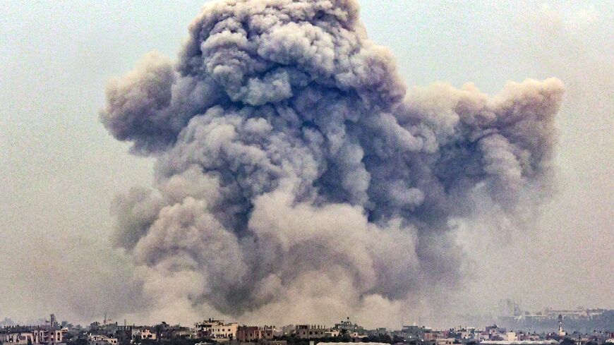 Seen from Rafah, smoke billows over Khan Yunis in the southern Gaza strip during Israeli bombardment 