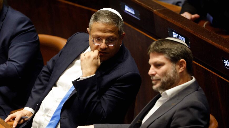Right-wing Knesset members Itamar Ben-Gvir (L) and Bezalel Smotrich, attend a special session at the Knesset Israel's parliament to approve and swear in a new right-wing government in Jerusalem on Dec. 29, 2022. 