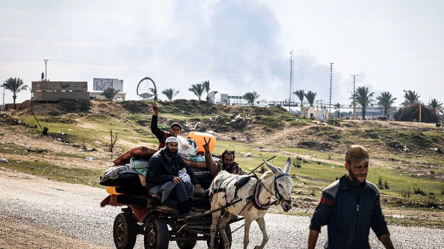 Palestinians flee Khan Yunis toward Rafah further south in the Gaza Strip as Israel bombards the city