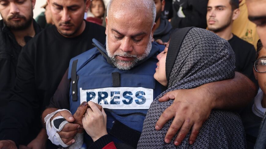 Al Jazeera's bureau chief in Gaza, Wael al-Dahdouh hugs his daughter during the funeral of his son Hamza Wael Dahdouh, a journalist, who was one of two reporters killed in an air strike in Rafah blamed on Israel 
