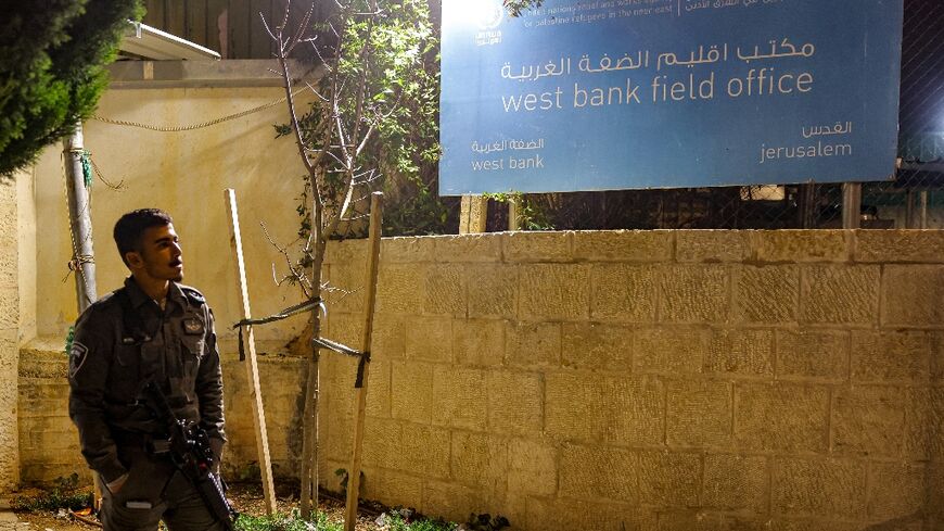 An Israeli border guard stands by during a protest by Israeli right-wing activists (not in frame) outside the West Bank field office of the United Nations Relief and Works Agency for Palestine Refugees (UNRWA) in Jerusalem 