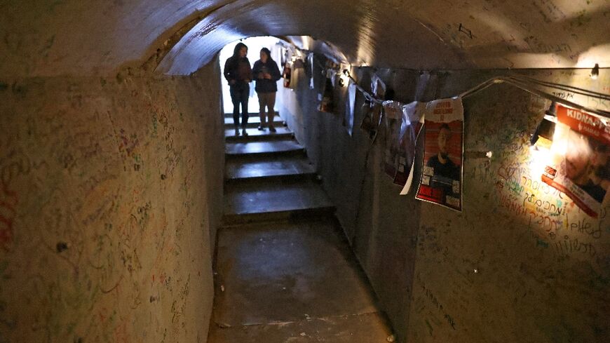 Portraits of hostages in a reconstruction of a Gaza tunnel in Tel Aviv's "Hostages Square"