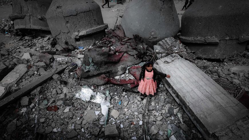 A Palestinian girl stands in the ruins of the Al-Faruq Mosque in Rafah on Friday