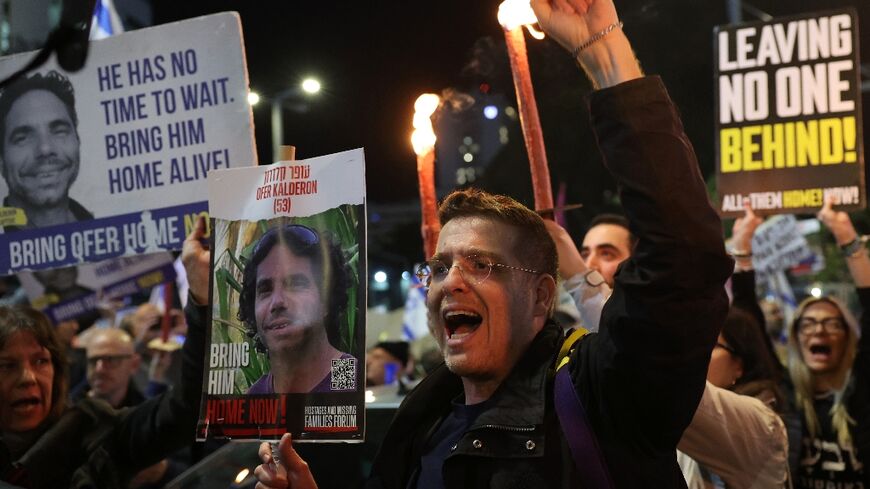 Protesters carry placards during a rally calling for hostage release in Tel Aviv