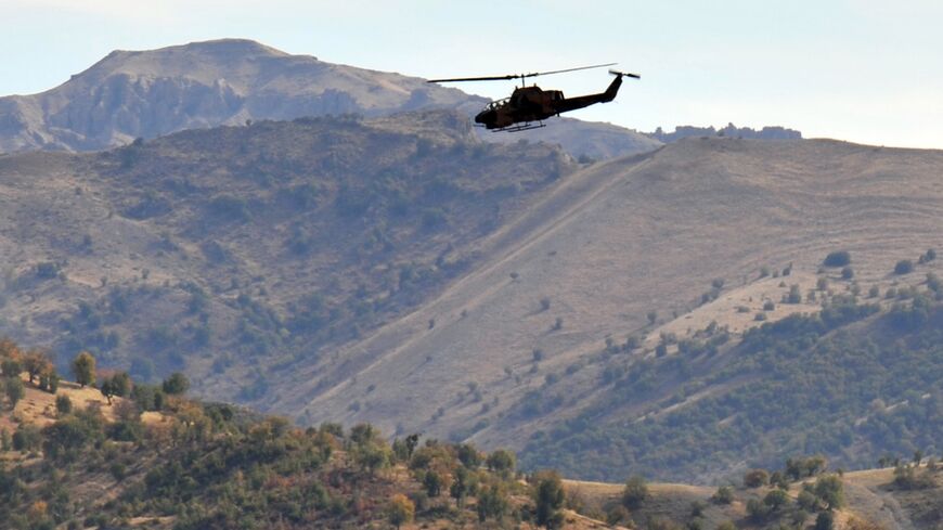 A photograph taken on Oct. 22, 2011, shows a Turkish military helicopter flying over a mountain in Yemisli, in the Hakkari province
