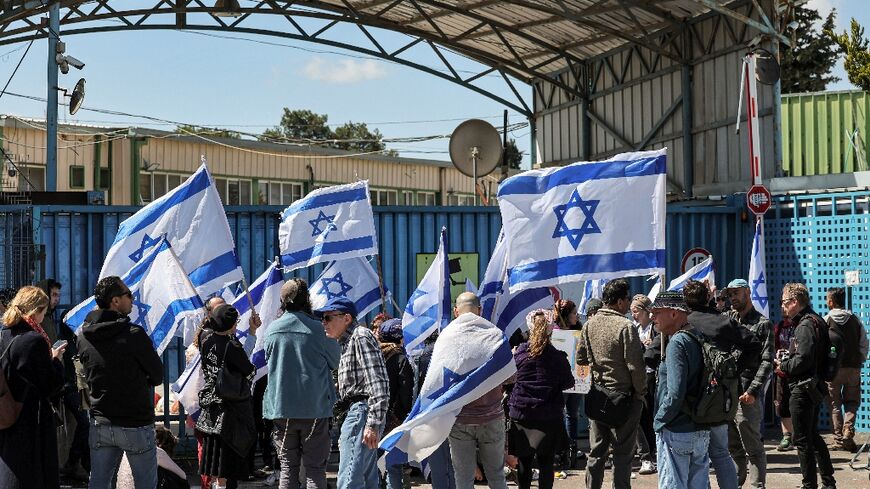 Right-wing Israelis protest outside the West Bank field office of the UN agency for Palestinian refugees (UNRWA) in annexed east Jerusalem calling for its break-up